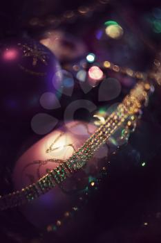 Christmas decorations on tree, vintage effect in purple colors.