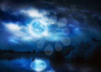 Rural landscape with river and full moon in the sky, photo manipulation.Elements of this image furnished by NASA