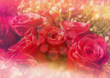 Romantic greeting card with bouquet of roses and textured bokeh effect.