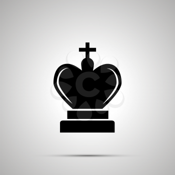 Simple black King chess icon with with shadow on gray