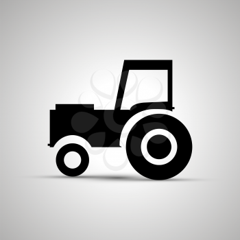 Tractor silhouette, side view simple black icon with shadow