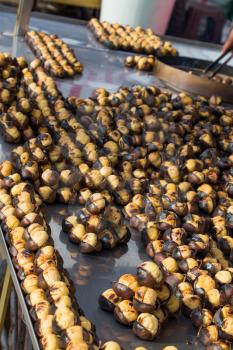 Organic brown chestnuts roasted over a hot fire