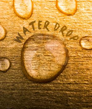 Water drop text and water drops on wooden surface
