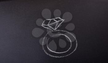 Diamond ring drawn on a blackboard in view