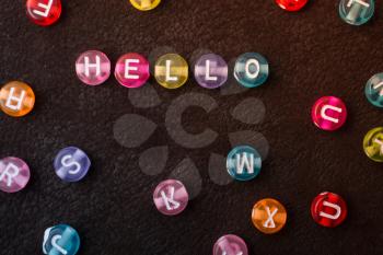 Hello wording formed with Multi color alphabet letter beads