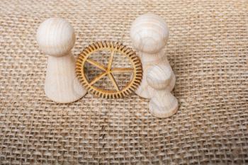 Wooden figurines of people and  and gear wheel concept