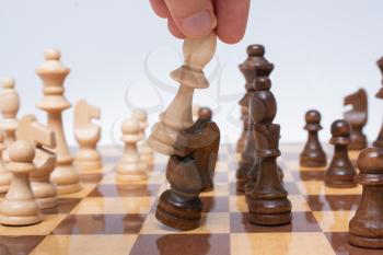 Hand making move on chessboard as strategy and leadership concept