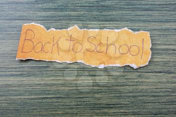 Back to school wording on a piece of torn paper