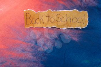 Back to school wording on a piece of torn paper