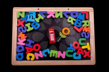 Telephone booth and colorful letters of Alphabet made of wood