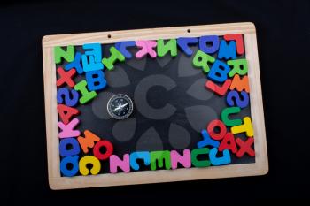 Compass and Colorful Letters of Alphabet made of wood