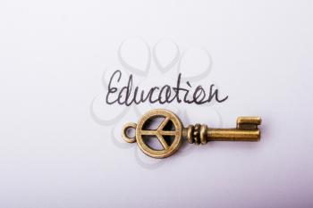 Education wording beside a retro style key  as education concpt
