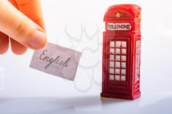 Notepaper with  wording English near the British telephone booth