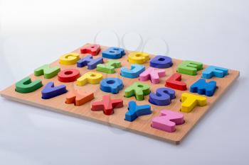Colorful letter blocks on board on white background