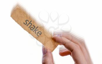 hand holding a piece of notepaper with shake wording