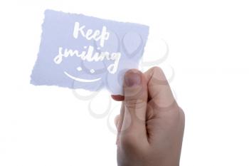 Keep smiling text on paper on a white background