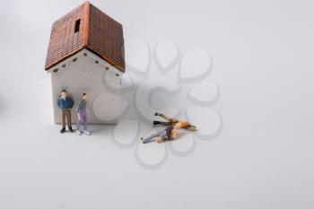 Figurine of men and  poor invalid man beside house