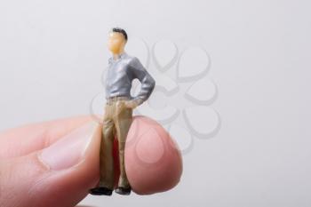 Tiny figurine of man miniature model in hand