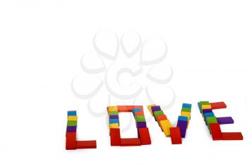 colorful wooden dominos write the word love on a white background