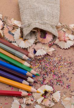 Colorful pencil shavings coming out of sack