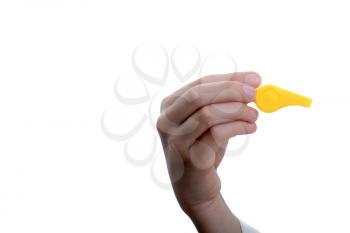 Hand holding a yellow whistle on a white background