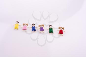 Colorful dressed children figures on a white background