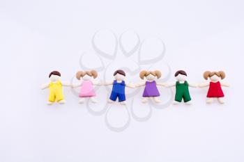 Colorful dressed children figures on a white background
