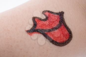 big red lips drawn on an arm