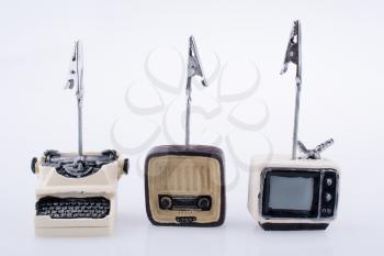 Retro syled tiny television, radio and typewriter model on a white background