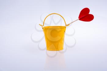 Little red color heart shape and yellow color bucket