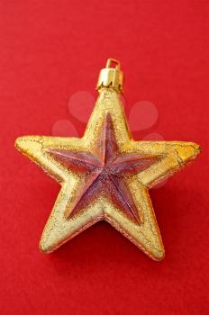 Christmas decoration. Golden star on red background.
