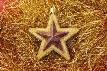 Christmas decorative star ornament on golden background.
