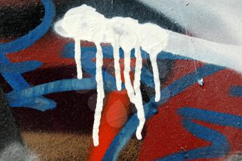 Dripping spray paint. Detail of a wall covered with graffiti.