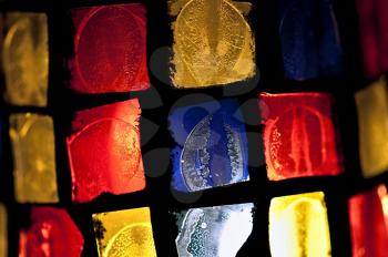 Colorful stained glass abstract squares pattern. Selective focus.