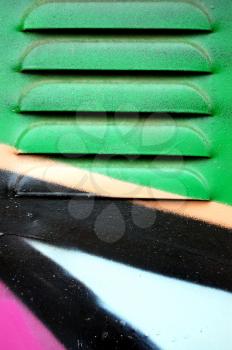 Detail of a metal surface covered with graffiti.