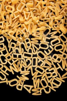 Alphabet soup letters pasta. Children's food background.