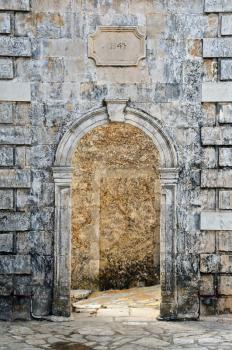 Arched gate weathered venetian belfry detail at village Louha in Zakynthos, Greece.