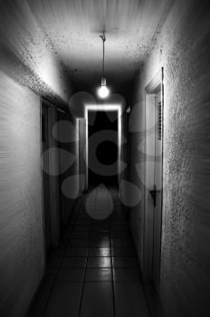 Light shining in dark basement corridor. Motion blur.