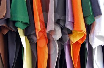 Row of colorful cotton t-shirts. Clothes background.