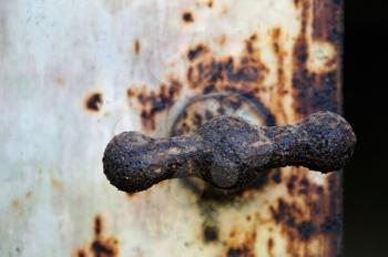 Rusty industrial metal door knob macro. Selective focus.