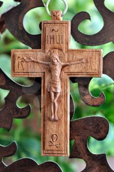 Wooden crucifix and rusty metal pattern background.