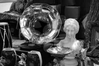 Vintage gramophone and antique objects at street fair. Black and white.