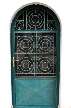Metal arched church door with concentric circles motif.
