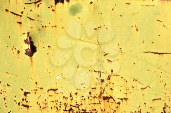 Chipped yellow paint on rusty iron. Metal texture industrial grunge background.