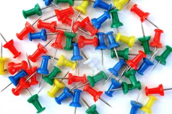 Colorful push pins on white background. 