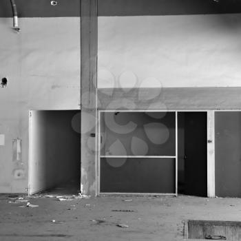 Empty room and concrete wall n derelict factory interior. Black and white.