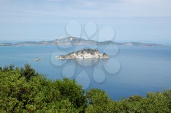 Small island sea and sky horizon landscape. Marathonisi islet, Zakynthos, Greece.