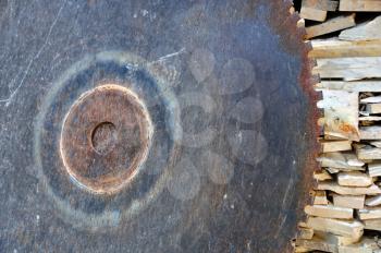 Vintage cutting wheel and pile of marble scrap. Rusty industrial equipment.