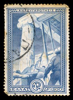 GREECE - CIRCA 1951. Vintage postage stamp printed for the financial aid program Marshall Plan under the U.S. assistance for the reconstruction of Europe, with workers restoring ancient monument illustration, circa 1951.
