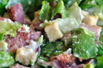 Caesar salad food background with lettuce, bacon and croutons. Selective focus.